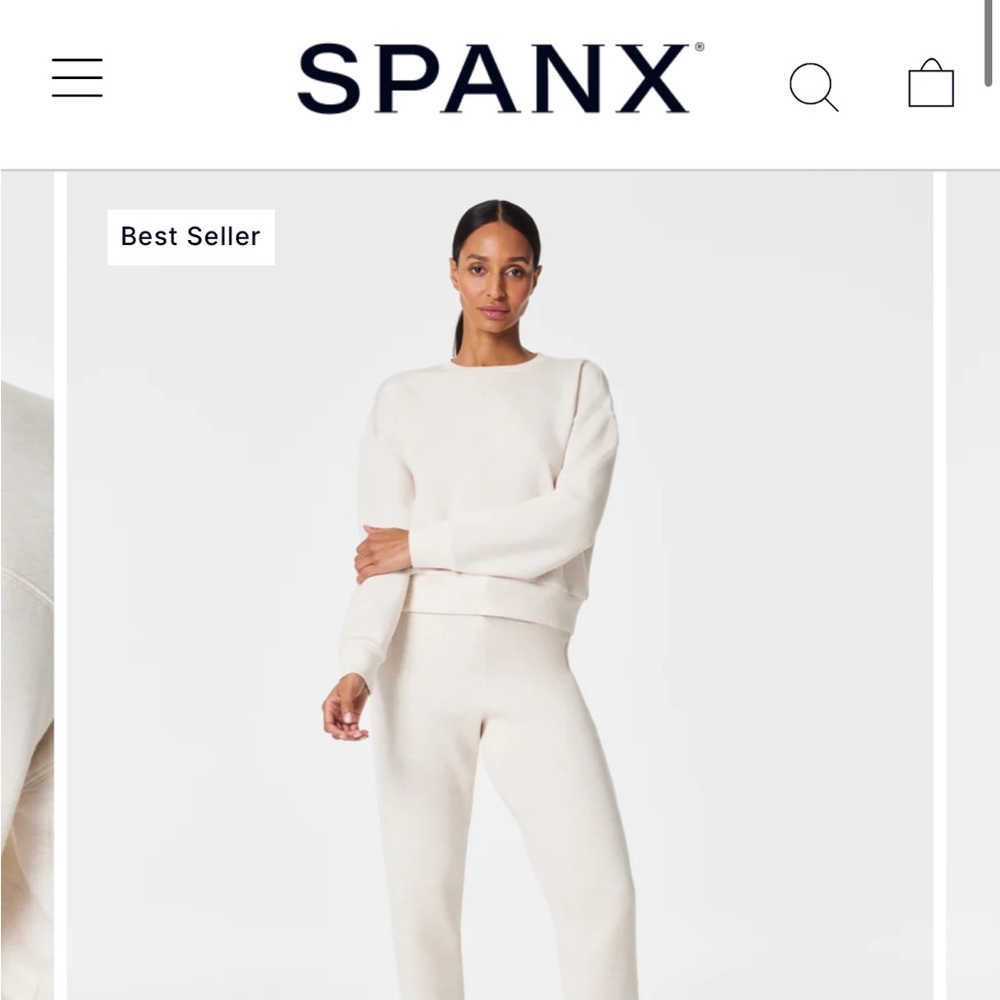 Spanx air essentials sweater in a light pink/dusty rose color.